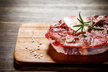 Raw beefseak on cutting board