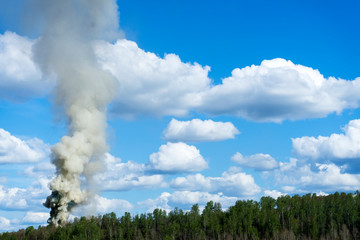 Plume of smoke from fire against the sky.