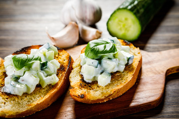 Bruschettas on cutting board on wooden background