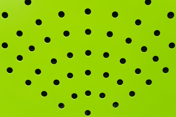 green spherical metal surface background with repetition holes