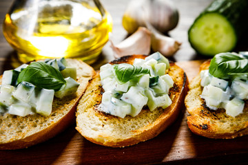 Bruschettas on cutting board on wooden background