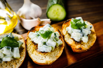Bruschettas on cutting board on wooden background