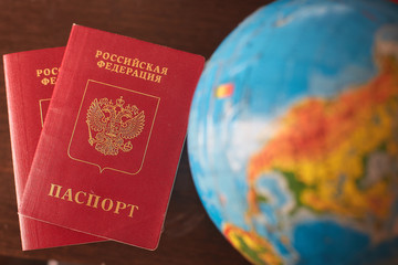 two Russian passports and a globe. Rest, travel