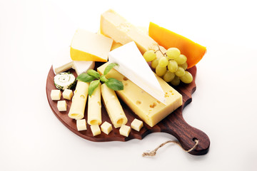 Cheese plate served with grapes, various cheese on a platter