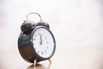 Vintage clock on blurred background.