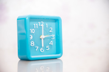 blue clock on blurred background.