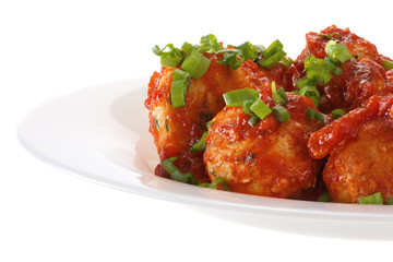 Meatballs in tomato sauce served on a plate. Isolated on white background.