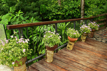 The Wooden Bridge over the pond with Flower Garden