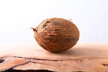 Whole single organic Tropical coconut  fruit on wodden background with copy space
