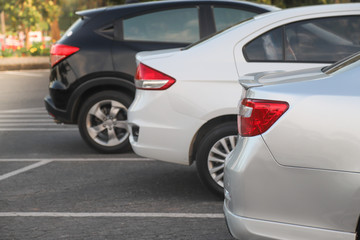 Fototapeta na wymiar Closeup of rear side of bronze car parking in parking lot.