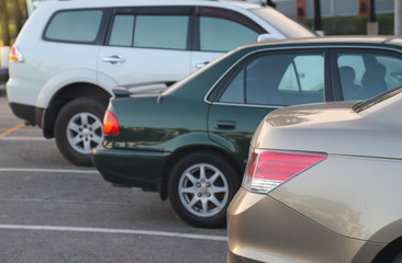Fototapeta na wymiar Closeup of rear side of pink gold car parking in parking lot.