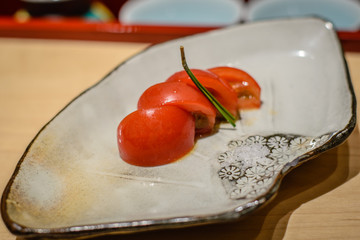 palate refresher cherry tomato with sea salt on a porcelain china plate