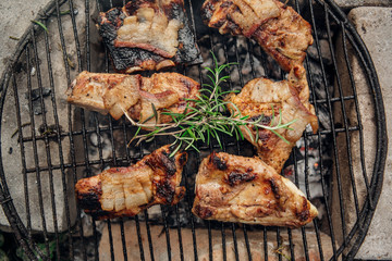 Pork ribs with rosemary on the grill from above