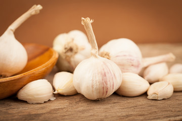 Set of garlic on old wooden table with brown background