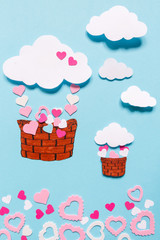Happy Valentines Day greeting card design with realistic paper. Handicraft, scrapbooking, handmade. Heart shape flying balloon and hearts decoration in blue background.