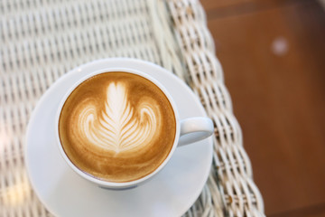 heart shape latte art of hot coffee drink tasty on white table in cafe