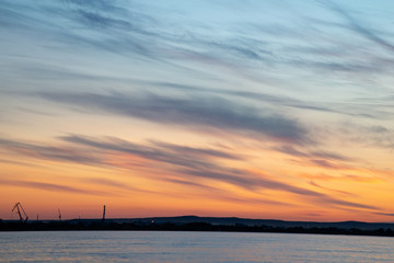 Beautiful sunset on the river. Summer sunset or sunrise landscape with golden light in Yakutia, Republic of Sakha, Russia. Riverscape taken from a ferry on river Lena