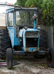 Fototapeta premium An old blue tractor full of rust parked somewhere in the South Island in New Zealand