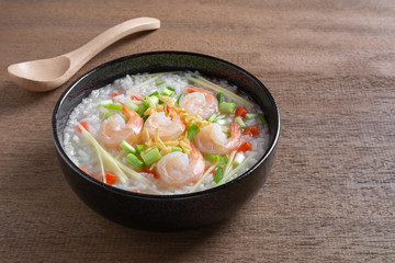 boiled rice with shrimp in a ceramic bowl on wooden table. homemade style food concept.