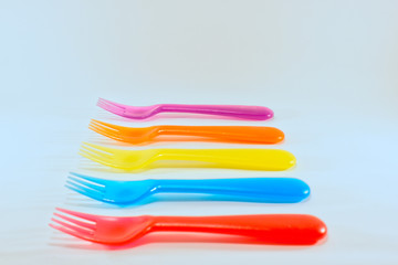 Colourful plastic forks isolated on white background