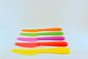 yellow red pink green orange knife isolated on a white background