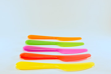 yellow red pink green orange knife isolated on a white background