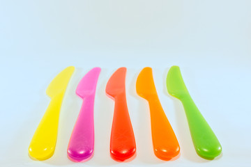 yellow red pink green orange knife isolated on a white background
