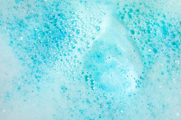 View of foam after dissolving color bath bomb in water, closeup