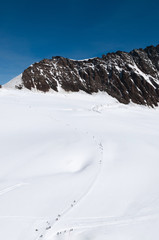 Tourist on winter landscape of Jungfraujoch, top of Europe Swiss alps scenery..