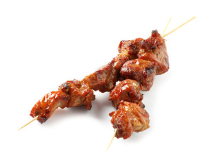 Skewers with delicious barbecued meat on white background