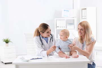 Fototapeta premium Woman with her baby visiting children's doctor in hospital