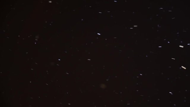 Christmas snowfall in the evening in the night sky