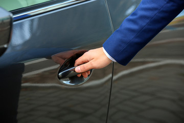 Naklejka premium Closeup view of man opening car door