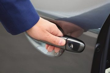 Closeup view of man opening car door