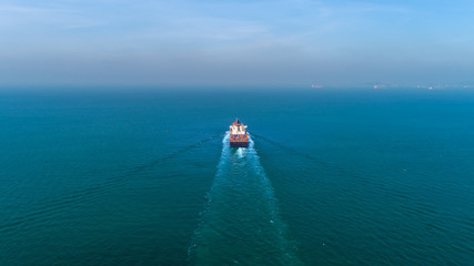 Aerial view container ship at sea for import export, shipping or transportation.