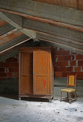abandoned house with big wooden closet and old chair