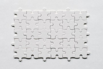 White jigsaw puzzle on a white bacground