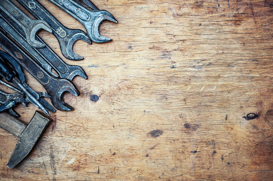 Old vintage hand tools on wooden background. Top view. With copy space