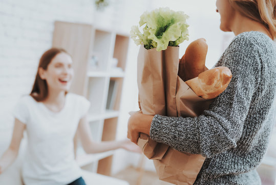 Mother with Packs of Food from Store at Home.