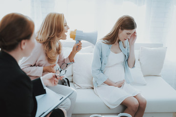 Mother with Pregnant Daughter in Doctor Office.