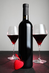 Bottle of red wine with a heart, love and Valentine's Day.