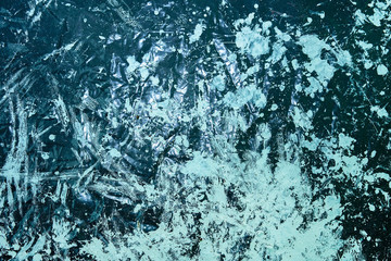 spots of white paint splashed on black oilcloth during apartment renovation