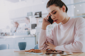 Serious nice woman having a phone conversation