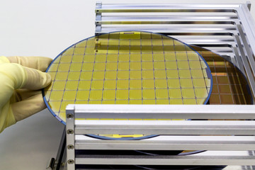 Silicon Wafers in steel holder box take out by hand in gloves- A wafer is a thin slice of...