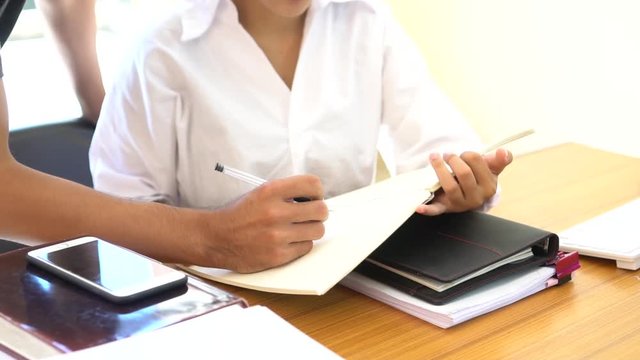 Co working team meeting plan concept:  Asian Business people working and studying together with tablet computer with documents in office, discuss finance and marketing solution reporting file in place