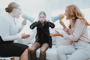 Upset Daughter in Jacket in Psychologist Office.