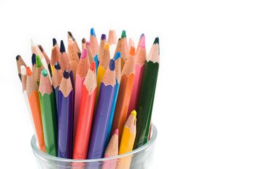 Bunch of colored pencils isolated on white background. Selective focus.
