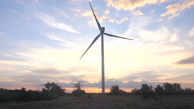 Wind power plant at sunset.  Time lapse