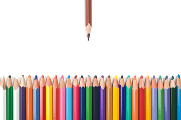 Colored pencils in a row isolated on white background.