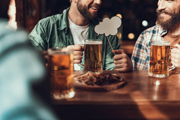 Cheerful friends with drinks spending time at pub